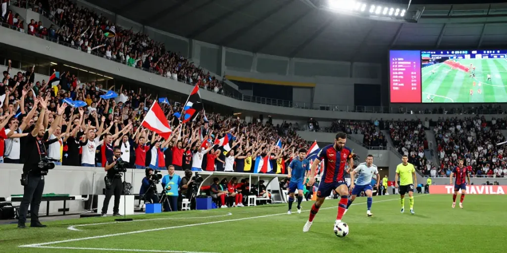Live soccer match with fans cheering and players in action, bóng đá cakhiatv experience.